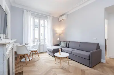 a living room with a couch and a table at ChezDudi in Nice