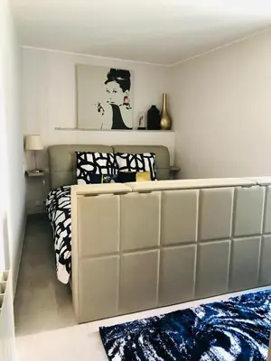 a bedroom with a bed with a bed frame at CHARMING APARTMENT NEAR THE BEACH in Villefranche-sur-Mer