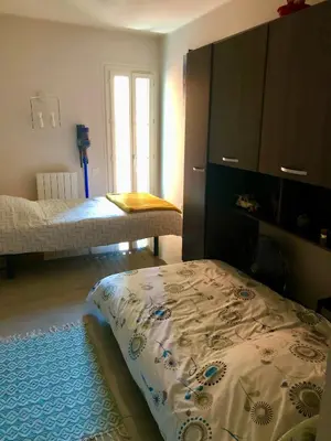 a bedroom with two beds and a dresser and a bed at CHARMING APARTMENT NEAR THE BEACH in Villefranche-sur-Mer
