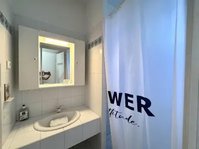 a bathroom with a toilet and a shower curtain at ApartHotel Riviera - BALCON HONORE 1 - Old Town - 5 mn Promenade des Anglais et Plage - Charme Absolu - Appartement 2 pièces avec Balcon AC - Vue mer et Ville in Nice