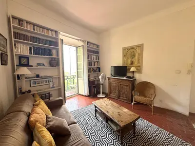 a living room with a couch and a coffee table at ApartHotel Riviera - BALCON HONORE 1 - Old Town - 5 mn Promenade des Anglais et Plage - Charme Absolu - Appartement 2 pièces avec Balcon AC - Vue mer et Ville in Nice
