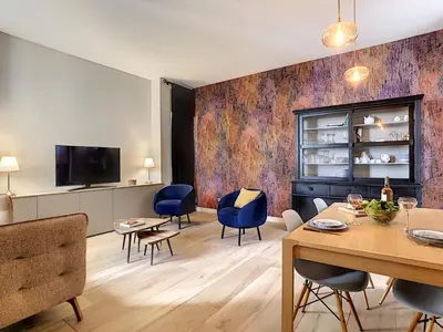 a living room with a table and chairs and a tv at Nestor&Jeeves - GLORY RIVIERA - Central - Close sea in Nice