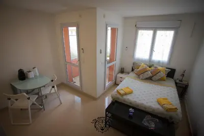 a bedroom with a bed and a table and a table at l'Or dans la Mer in Nice