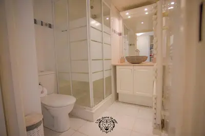 a bathroom with a toilet and a glass shower at l'Or dans la Mer in Nice