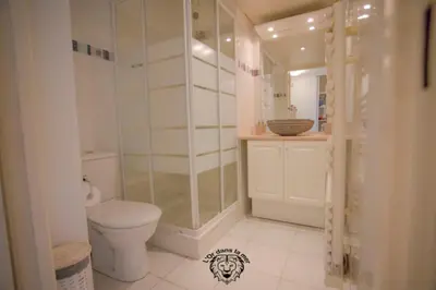 a bathroom with a toilet and a glass shower at l'Or dans la Mer in Nice