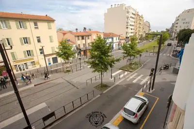 a white car parked on a city street with buildings at l'Or dans la Mer in Nice