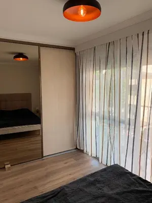 a bedroom with a bed and a large window at Superbe 2 pièces à 50 m de la Promenade des Anglais in Nice