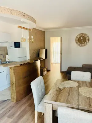 a living room with a table and a kitchen at Superbe 2 pièces à 50 m de la Promenade des Anglais in Nice