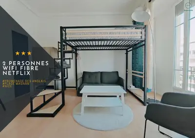 a room with a bunk bed with a couch and a table at Joli Studio - Promenade des Anglais - Accès plage in Nice