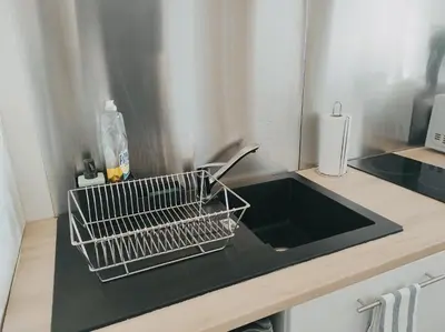 a kitchen counter with a black sink and a counter top at Joli Studio - Promenade des Anglais - Accès plage in Nice