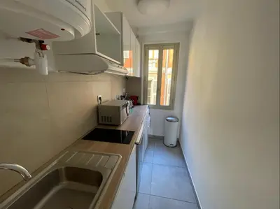 a small kitchen with a sink and a window at Nice Renting - JAURES - Cosy Flat - Nice old town - Great view - AirCon in Nice