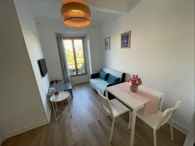 a living room with a table and a couch at Nice Renting - JAURES - Cosy Flat - Nice old town - Great view - AirCon in Nice