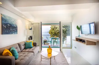 a living room with a couch and a table at I love Nice - FACE MER, DESIGN, TERRASSE, ASC, WIFI, CLIM in Nice