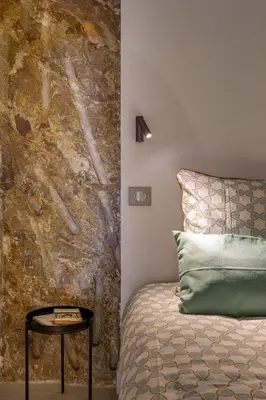 a bedroom with a bed and a table next to a wall at I love Nice - FACE MER, DESIGN, TERRASSE, ASC, WIFI, CLIM in Nice
