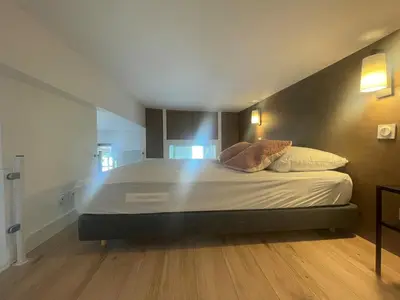 a large bed with two pillows on it in a room at Garibaldi 11 in Nice