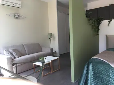 a living room with a couch and a table at Palais Gioffredo place Massena in Nice