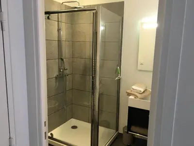 a shower with a glass door in a bathroom at Palais Gioffredo place Massena in Nice