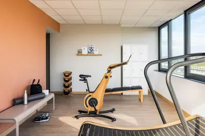 a gym with a treadmill and a elliptical machine at OKKO Hotels Nice Aéroport in Nice