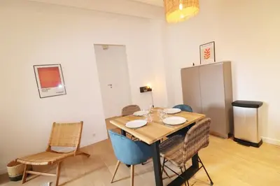 a dining room with a table and chairs at Superbe Appartement au coeur de la vieille ville in Villefranche-sur-Mer