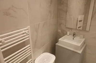 a bathroom with a sink and a toilet and a mirror at Superbe Appartement au coeur de la vieille ville in Villefranche-sur-Mer