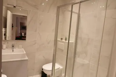 a bathroom with a shower and a toilet and a sink at Superbe Appartement au coeur de la vieille ville in Villefranche-sur-Mer