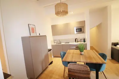 a kitchen and dining room with a table and chairs at Superbe Appartement au coeur de la vieille ville in Villefranche-sur-Mer