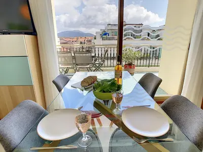 a glass table with two wine glasses on a balcony at Nestor&Jeeves - SUNRISE TERRACE - Central - Very close sea - Terrace 30m in Nice