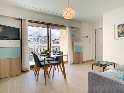 a living room with a table and chairs and a couch at Nestor&Jeeves - SUNRISE TERRACE - Central - Very close sea - Terrace 30m in Nice