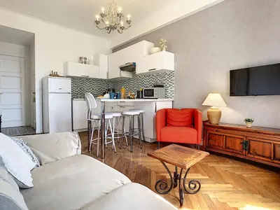 a living room with a couch and a kitchen at Nestor&Jeeves - HAPPINESS BEACH - Central - Close sea - Top floor in Nice