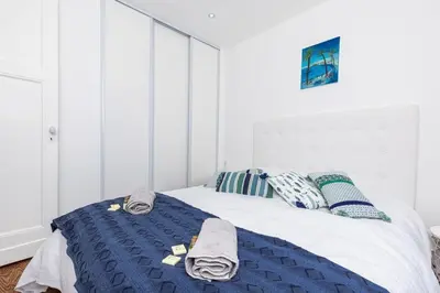 a bedroom with a bed with a blue blanket at MY CASA - SPITALIERI- Sunny Terrace with view in Nice