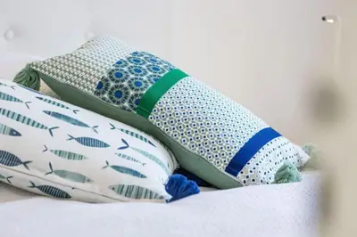 a pile of pillows sitting on a bed at MY CASA - SPITALIERI- Sunny Terrace with view in Nice