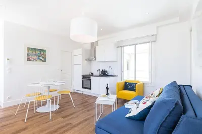 a living room with a blue couch and a table at MY CASA - SPITALIERI- Sunny Terrace with view in Nice