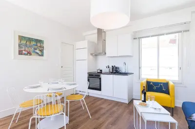 a kitchen and living room with a table and chairs at MY CASA - SPITALIERI- Sunny Terrace with view in Nice