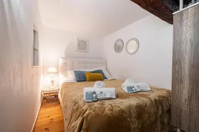 a bedroom with a bed with two pillows on it at MY CASA - PONT VIEUX - Duplex Old Town Near Place Rossetti in Nice
