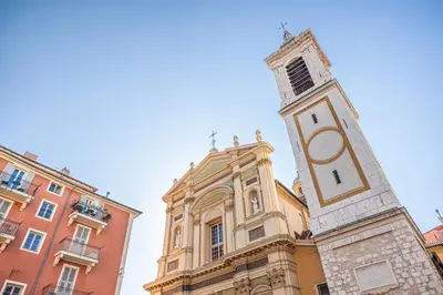 a building with a clock tower in front of it at MY CASA - PONT VIEUX - Duplex Old Town Near Place Rossetti in Nice