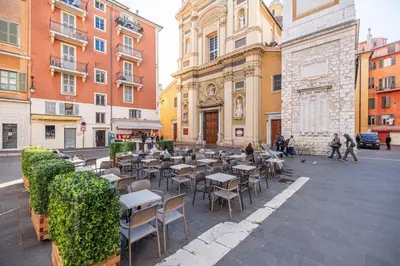 a city street with tables and chairs and buildings at MY CASA - PONT VIEUX - Duplex Old Town Near Place Rossetti in Nice