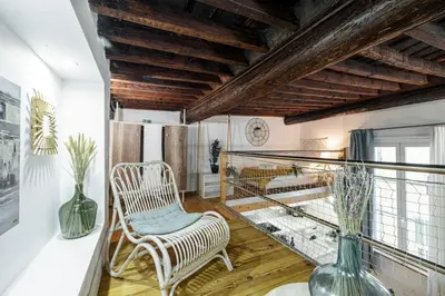 a room with a balcony with a chair and vases at MY CASA - PONT VIEUX - Duplex Old Town Near Place Rossetti in Nice