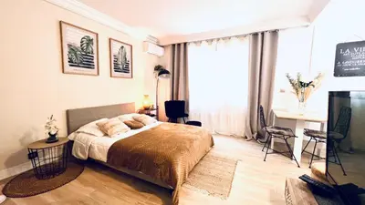 a bedroom with a bed and a desk and a window at LE MIRAMAR Nice - Clim, Parking, Wifi et piscine in Nice