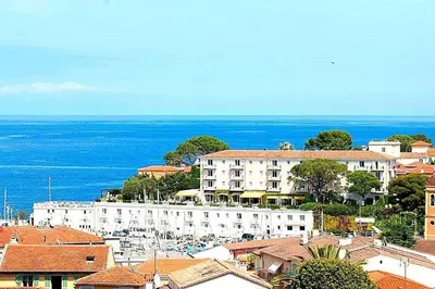 a view of a city with buildings and the ocean at AMAZING SEA VIEW APARTMENT with Private Close Parking in Saint-Jean-Cap-Ferrat