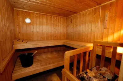 a wooden sauna with a black bucket in it at AMAZING SEA VIEW APARTMENT with Private Close Parking in Saint-Jean-Cap-Ferrat