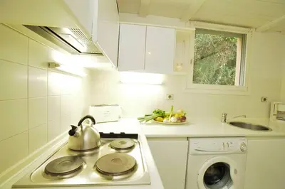 a kitchen with a stove with a tea kettle on it at AMAZING SEA VIEW APARTMENT with Private Close Parking in Saint-Jean-Cap-Ferrat