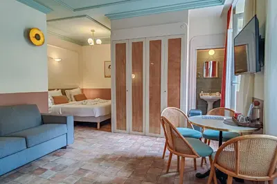 a living room with a couch and a table at Hotel Aparthotel AMMI Vieux Nice in Nice