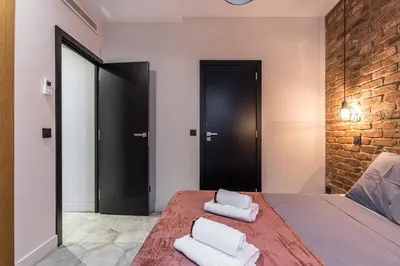 a bedroom with a bed with two towels on it at FEEL HOME - BUNICO in Nice