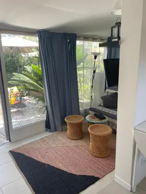 a living room with a large sliding glass door at Cozy house with parking and garden in Nice