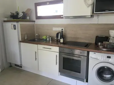 a kitchen with a sink and a washing machine at Cozy house with parking and garden in Nice