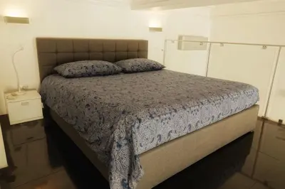 a bedroom with a bed with a blue comforter at Alexandre Mari old town few meters to the beach in Nice