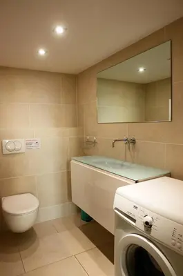 a bathroom with a toilet and a sink and a washing machine at Alexandre Mari old town few meters to the beach in Nice