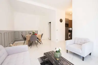 a living room with a couch and a table at Le Magenta - Happy Rentals in Nice