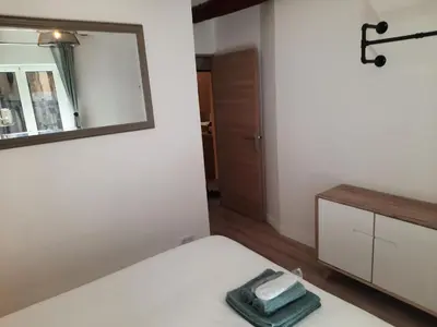a bedroom with a white bed and a mirror at Beautiful Old Town flat, near the beach in Nice