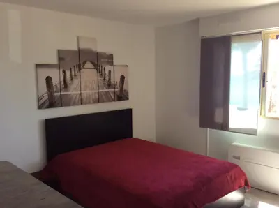 a bedroom with a bed and a picture of a bridge at Poseidon in Cagnes-sur-Mer